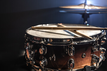 Fototapeta na wymiar Part of a drum kit, snare drum on a dark background.