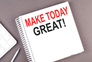 MAKE TODAY GREAT text on notebook with calculator and pen