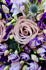 Bouquet of purple roses and thistle flowers