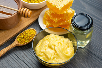 Fresh flower honey of different varieties, pollen and honeycomb with spoons on a wooden background. Organic Vitamin Health Food