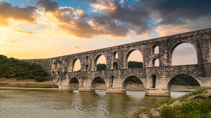 Fototapeta na wymiar Maglova Aqueduct Istanbul Turkey, Maglova Aqueduct built by Master Ottoman Architect Mimar Sinan, Beautiful sunset aqueduct