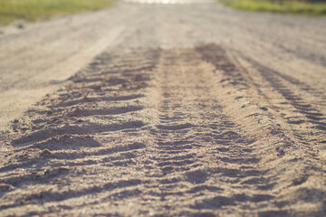 Tire tracks in sand of countryside road. 
