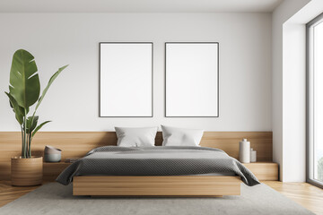 Bright bedroom interior with large bed, two empty posters