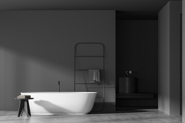 Naklejka na ściany i meble Dark bathroom interior with empty grey wall, bathtub, towel