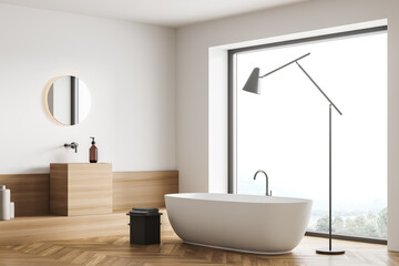 Corner view on bathroom interior with bathtub, panoramic window