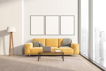 Bright living room interior with three white empty posters