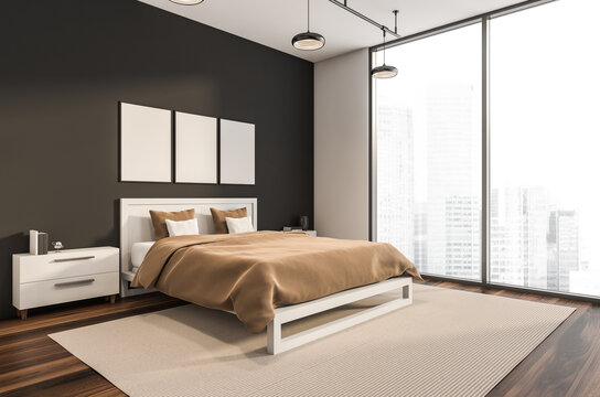 Dark bedroom interior with three empty white posters, panoramic window
