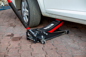 Tire change of a car. placing a jack under the car