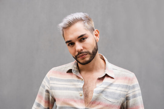 Young transgender man looking at camera outdoor at the city - Focus on face