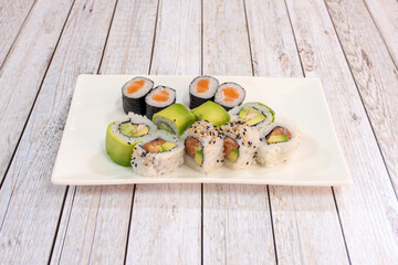 Sushi maki roll and uramaki california roll with Norwegian salmon, white rice, Japanese vinegar,...