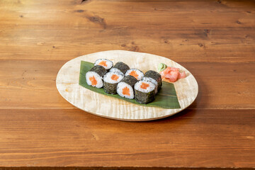 Eight servings of sushi maki roll stuffed with Japanese rice with vinegar and Norwegian orange salmon rolled with nori seaweed, wasabi and ginseng