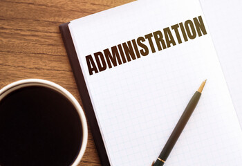 ADMINISTRATION - text on notepad on wooden desk.