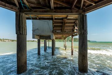Concrete piles that support the madera structure of some bungalows on the Andaman Sea in Phuket, Thailand
