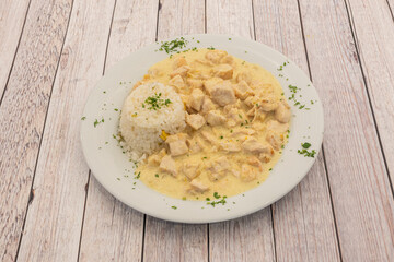 Traditional Mexican popular recipe of pumpkin flower chicken stew with white rice and chopped parsley