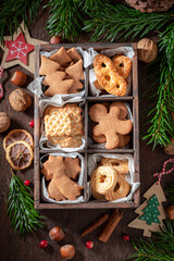 Tasty Christmas gingerbread cookies in small wooden box with paper