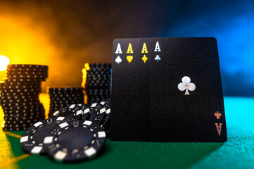 Black poker cards - four aces - a symbol of win, luck and stacks of chips. Beautiful background. Close-up. Casino, online casino, gambling, game strategy.