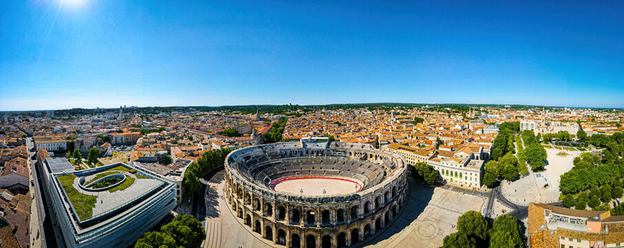 The aerial view of Arena of Nîmes, an old Roman city in the Occitanie region of southern France