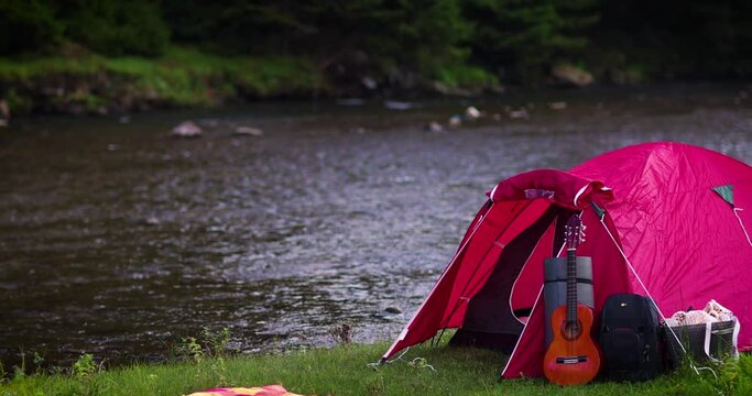 torist tent camping in mountains near the river. active leisure