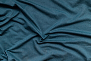 Fototapeta na wymiar wavy greenish fabric texture. abstract