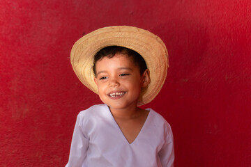 Hispanic boy smiling wearing traditional costume of latin america, central America, Mexico, Nicaragua, Costa Rica, Honduras, El Salvador, Colombia, Venezuela.  - obrazy, fototapety, plakaty