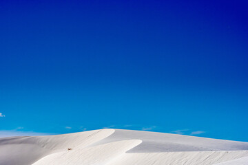 Blue Sky Over Winding Crest Of White Sand Dunes