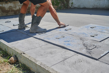 worker placing mold on printed concrete