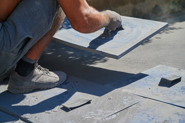 worker placing mold on printed concrete