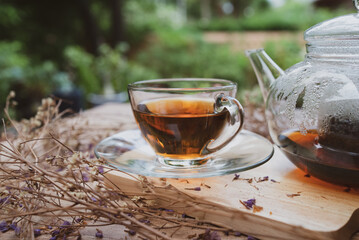 black hot tea in teacup served on table in cafe