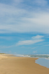 Fototapeta na wymiar sand beach and blue sky. vertical orientation. copy space.