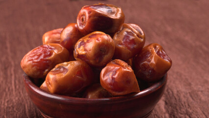 Dates in wooden bowl on background. dried dates fruit.