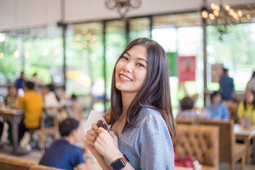 Beautiful happy asian women standing in coffee shop