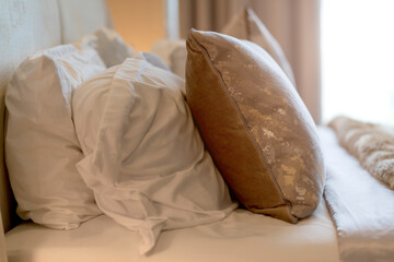 close up soft beatiful bedroom pillows arrange setting in hotel bedroom with morning light from window curtain interior design ideas concept