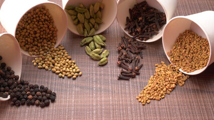 Dry coriander seeds with small bamboo spoon and green fresh bunch coriander leaves,famous spices ingredients in asia's kitchen.