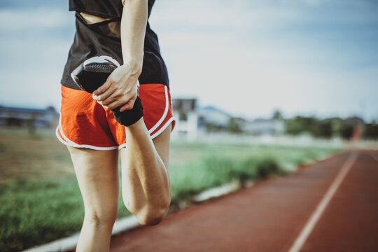 A beautiful woman stretching her body before running in the morning with a bright smile on her face. women's health care concept