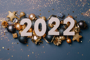 Celebrating the new year 2022. Date numbers 2022 on a background of Christmas toys, balls,...