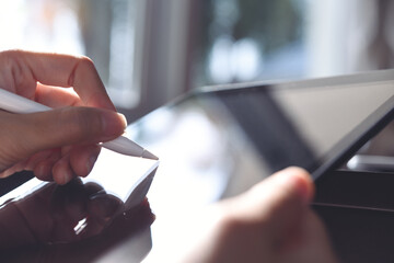 Woman using stylus pen on digital tablet computer, close up © tippapatt