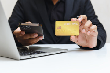 businessman holding credit card using smartphone,  purchase and payment concept.