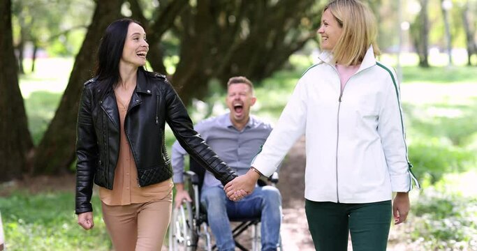 Man in wheelchair screaming and trying to catch up with two women 4k movie