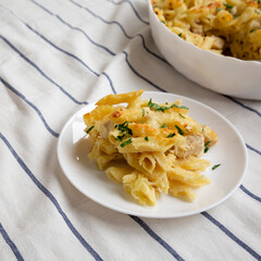 Homemade Chicken Alfredo Pasta Bake with Parsley, side view.