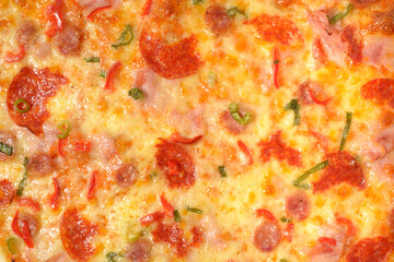 Delicious pepperoni pizza with cheese, salami and ham. Original italian classic fresh pizza. High resolution close up