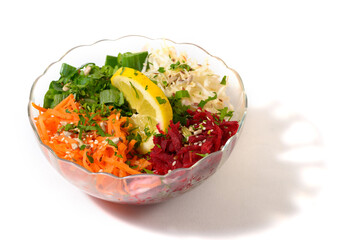 Fresh healthy vegan salad with carrots, celery, beet and green onions in glass bowl. Tasty snack for a healthy body and mind.