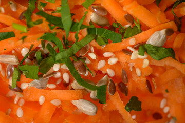 Fresh healthy vegan salad with carrots, various seeds and fresh parsley. High resolution close up macro photo