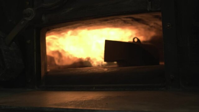 oven’s door is opening and reveal the fire going out of furnace head or bigmouth