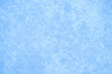Luminous festive background of blue ice with a white ice pattern with a natural haze effect. Background