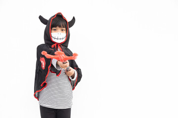 Asian little girl in a Halloween costume in a medical mask . Halloween with safety measures from Covid-19
