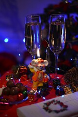 christmas table setting burning candle and champagne glasses