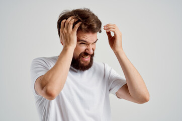bearded man holding his head pain stress emotions Studio treatment