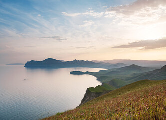Stunning scenery in the sunset rays of the sea coast and mountains. Black Sea coast, view of Koktebel, massif Karadag