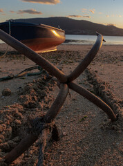 Anchor holding a boat in the sand on the beach.