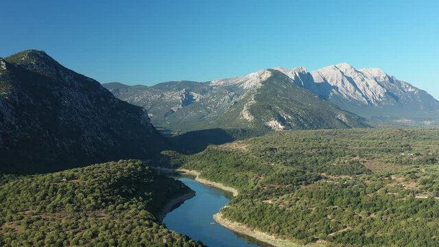 View from above, stunning aerial view of the Cedrino Lake - Lago del Cedrino, surrounded by the mountain range of Supramonte located northeast of the Gennargentu massif. Sardinia, Italy.